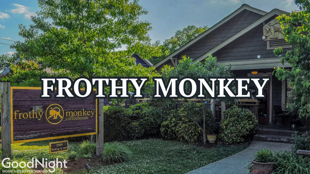 This image captures the exterior of Frothy Monkey, a popular local coffee shop. The scene shows the building's inviting architecture, tasteful landscaping, and outdoor seating, all framed by the shop's recognizable signage. The relaxed atmosphere is welcoming, suggesting a place for informal meetings, networking, or a productive coffee break near Midtown's business centers.